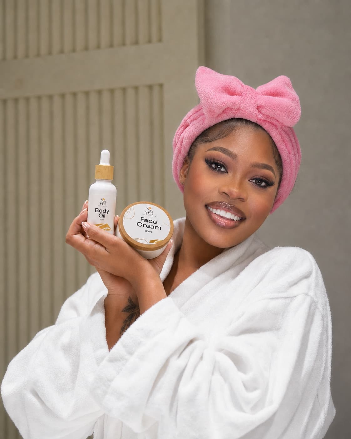 VEL model holding Face Cream and Body Oil